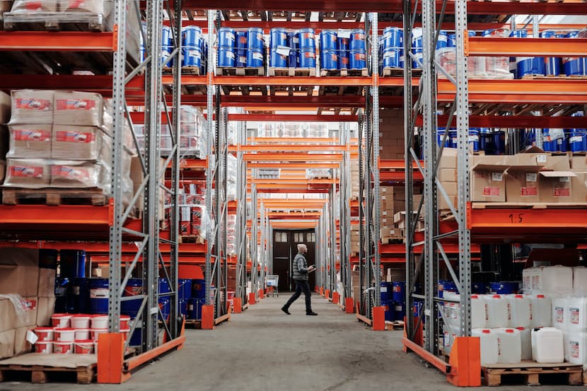 Man searching through warehouse inventory.