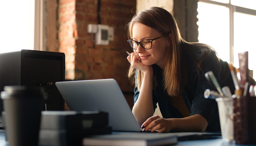 A girl works at a computer in a modern office