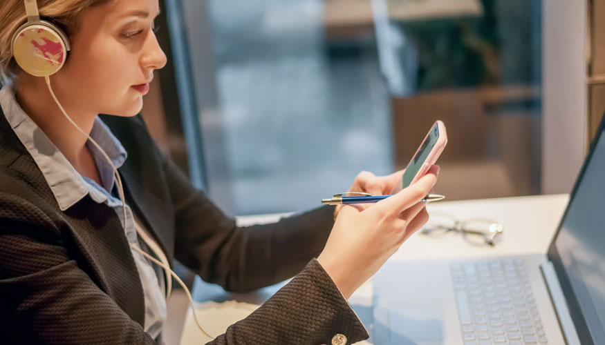 Business woman with headphones, smartphone and laptop work in cafe.