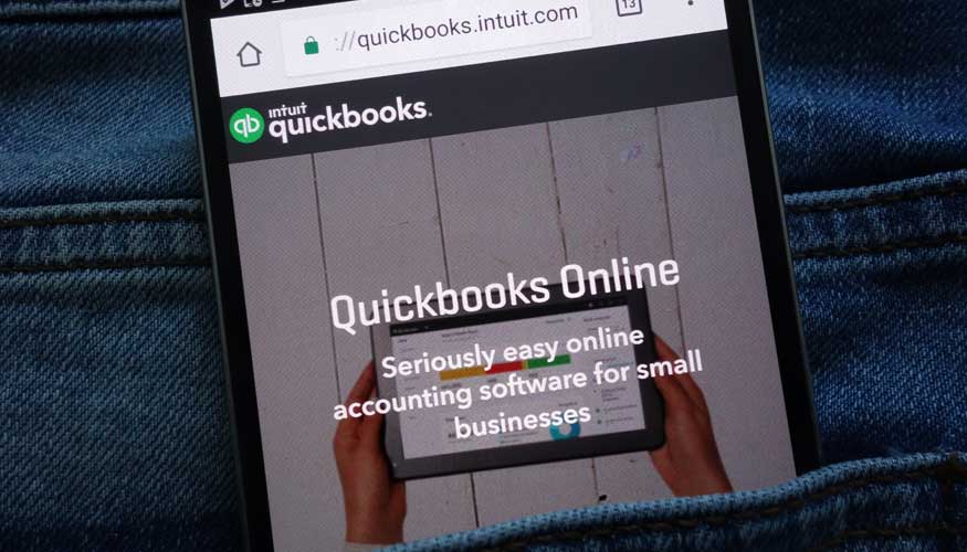 KONSKIE, POLAND - JUNE 11, 2018: Intuit Quickbooks website displayed on smartphone hidden in jeans pocket