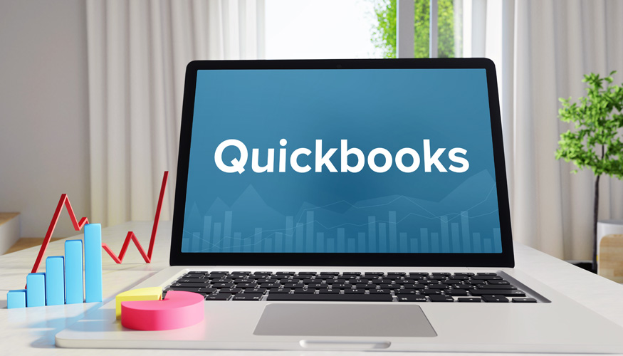 Quickbooks – Statistics/Business. Laptop in the office with term on the display. Finance/Economics.