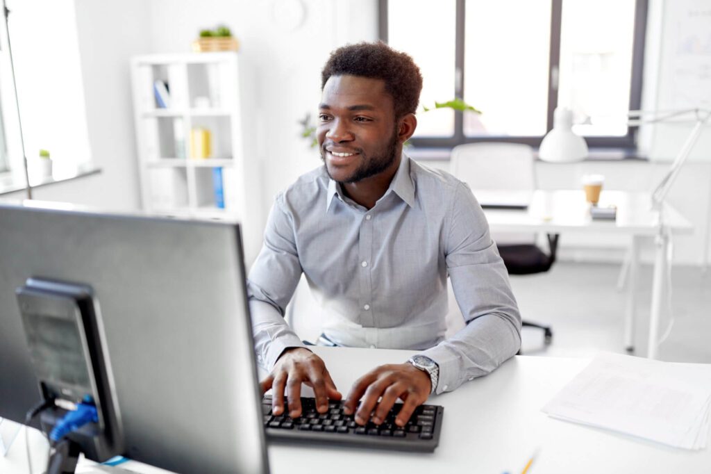 african businessman works with computer at office