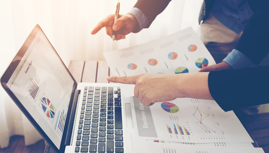 Team of business investment consultant analyzing company annual financial report balance sheet statement working with documents graphs.