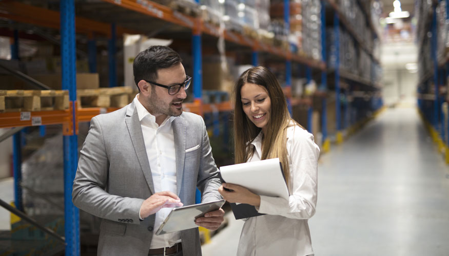 Warehouse management team checking organization and distribution in storage shipping center.