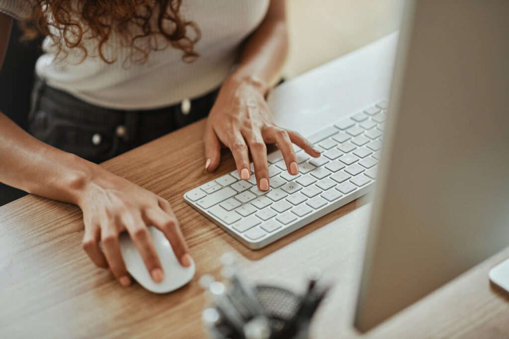 Business woman hands, computer mouse and keyboard.