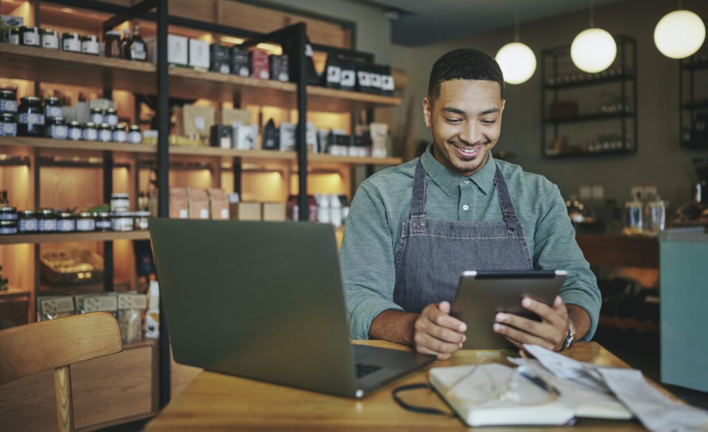 Small business owner working on payroll management through his computer.