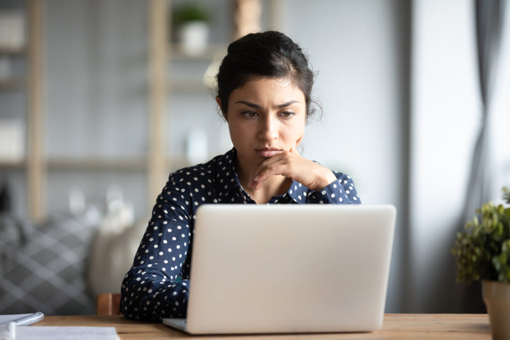 Woman concentrating while working on her computer.