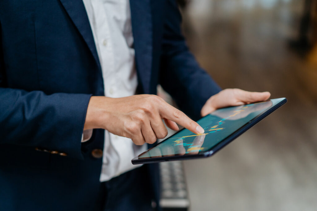 Businessman checking QuickBooks on digital tablet. 